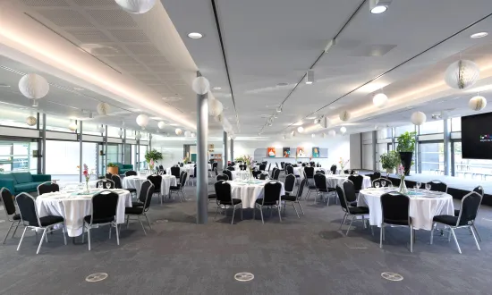 Tables dressed for a dinner party with flowers on top. 