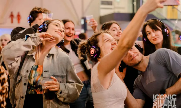 A group of people wearing headphones enjoying a disco