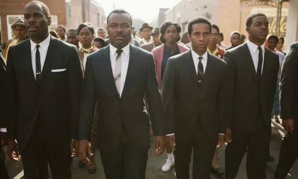 A promotional image for the film Selma with 4 men in suits walking towards the camera.