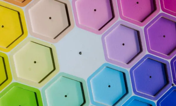 A number of hexagonal shapes are arranged in a rainbow format.
