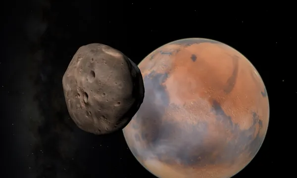 An image of the planet Mars, and it's moon Phobos slightly in front