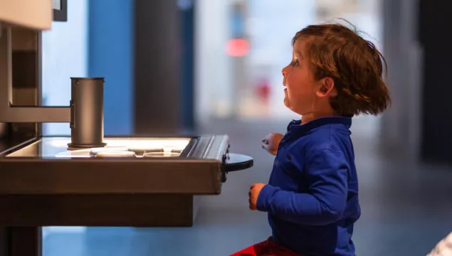 child sitting in front of a table