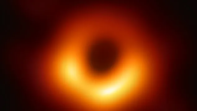 Bright donut shape of orange light on a black background.