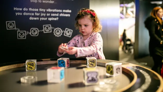 A small child plays with some cubes on top of an electric surface