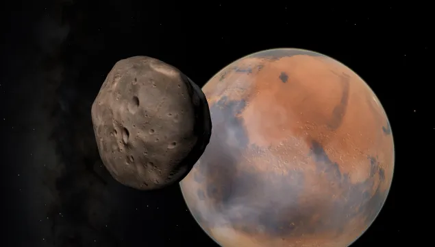 An image of the planet Mars, and it's moon Phobos slightly in front