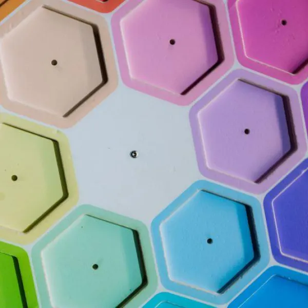 A number of hexagonal shapes are arranged in a rainbow format.